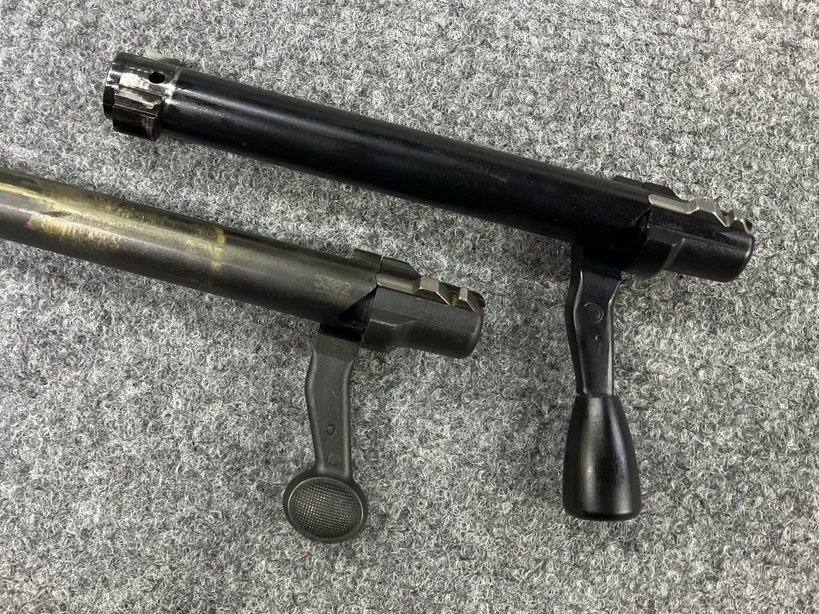 Factory Remington 700 bolt handle next to a bolt handle threaded for a PTG teardrop knob