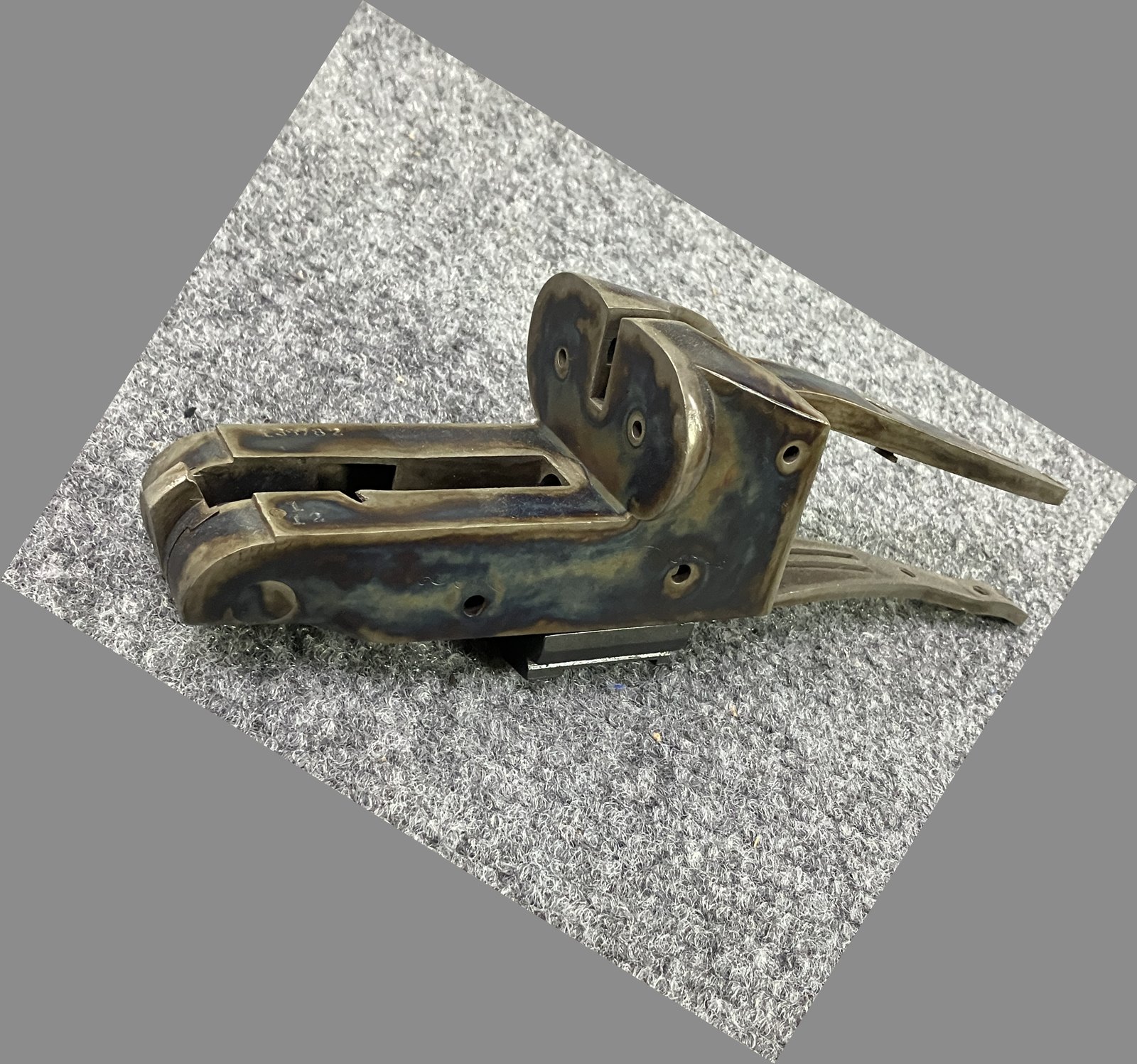Color case-hardened shotgun receiver, oriented left to right
