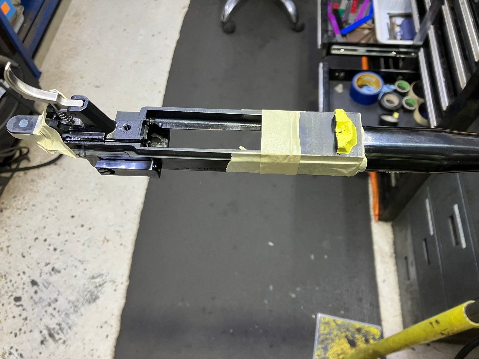 Barreled action masked with tape, including the recoil lug, before contact with Acraglas