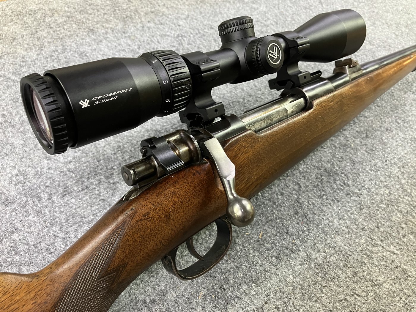 Side view looking along the bolt showing bent handle and low-profile safety under the scope