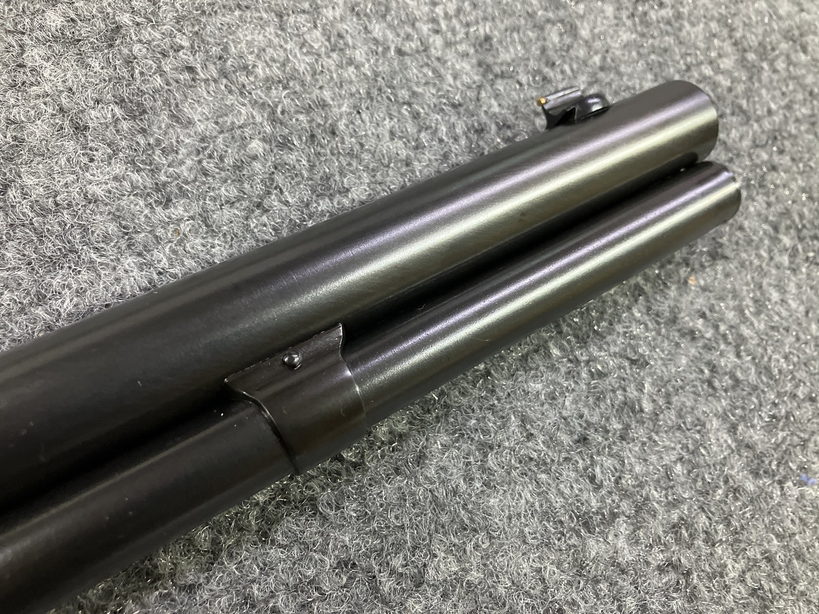 Recent rust-blued rifle barrel and magazine tube showing the grayish blue finish