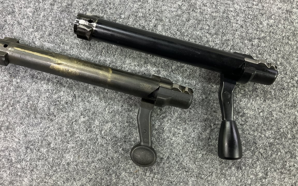 Factory Remington 700 bolt handle beside a PTG teardrop knob on a threaded handle