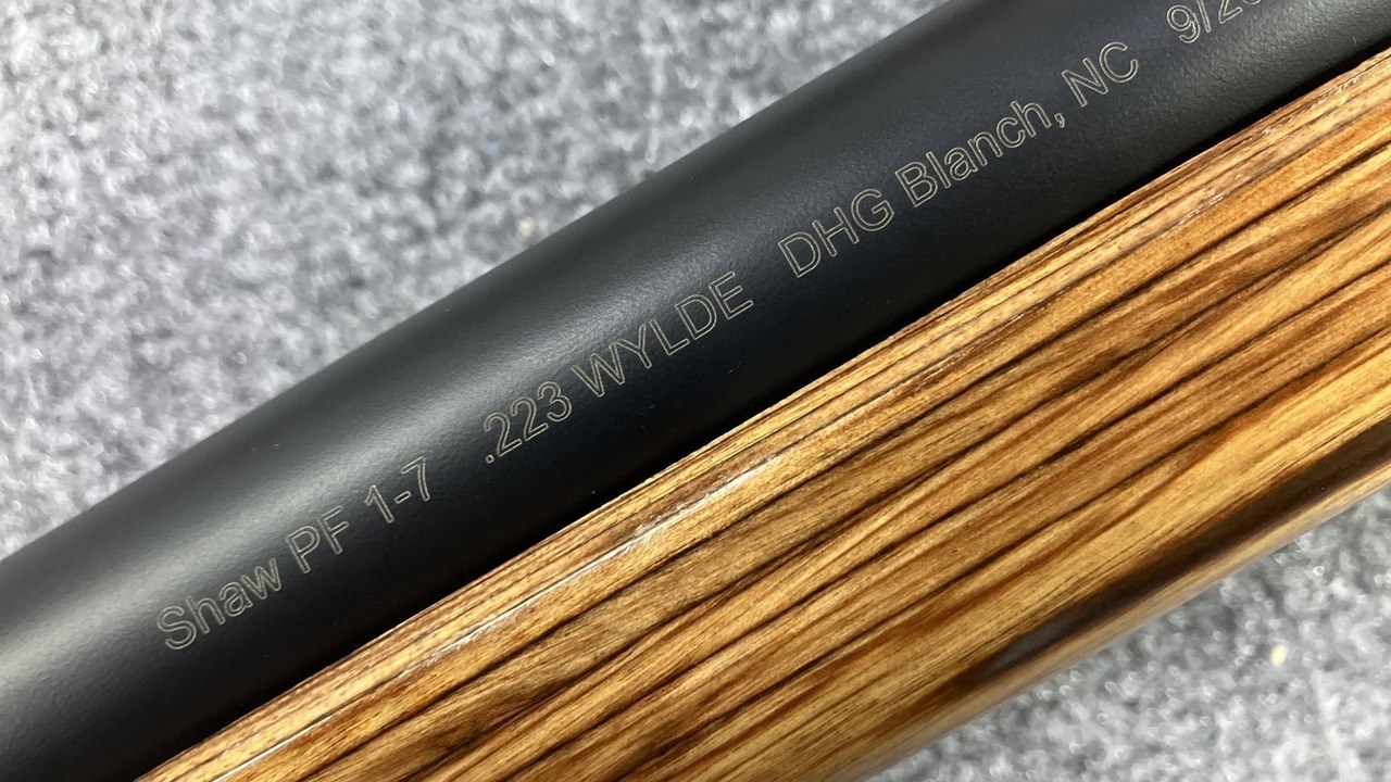 Laser engraved Shaw PF .223 Wylde marking on a Cerakoted stainless barrel with a light laminate stock