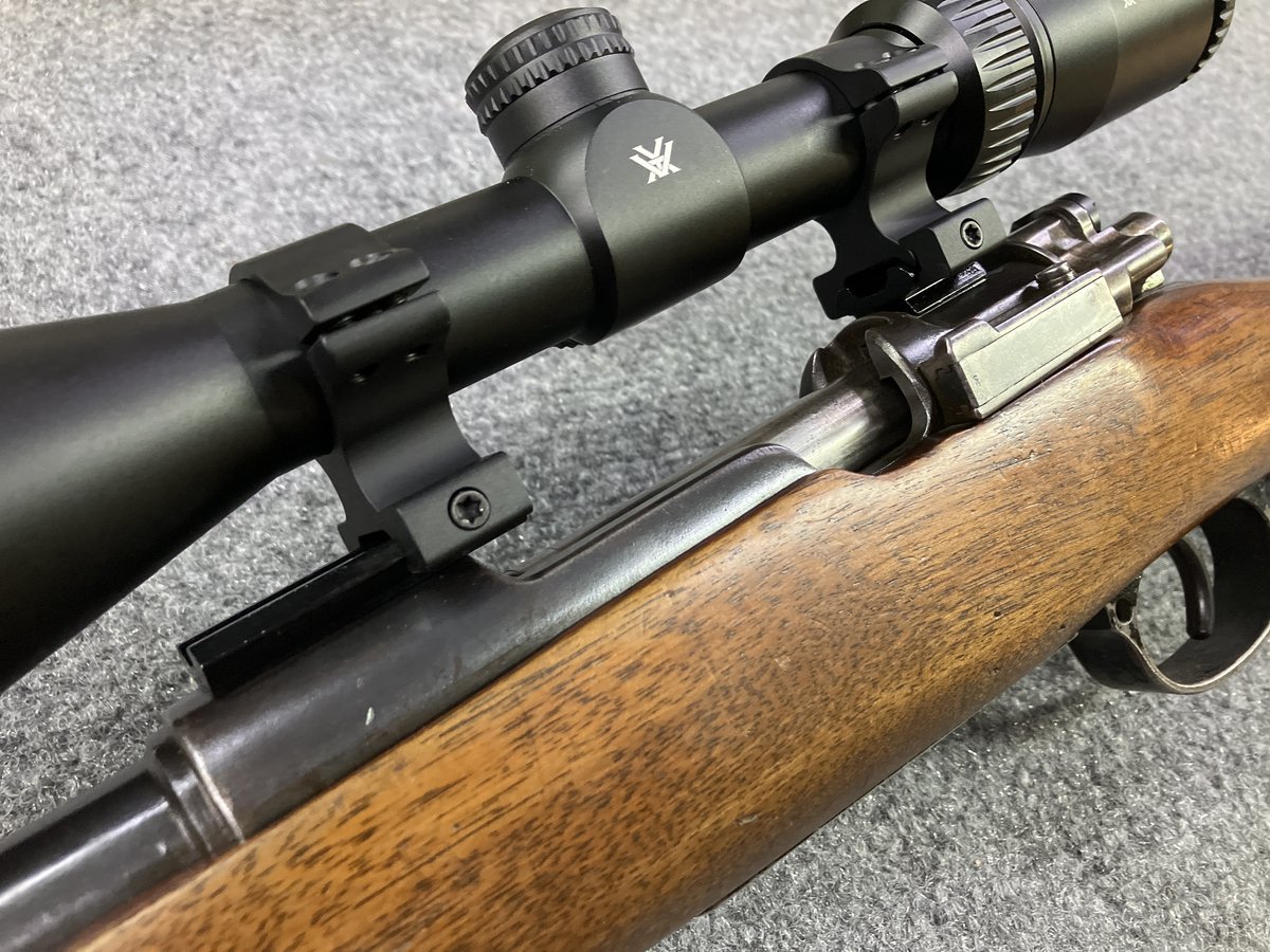 Vortex scope mounted low on a Mauser-style action with bent bolt handle and low-profile safety