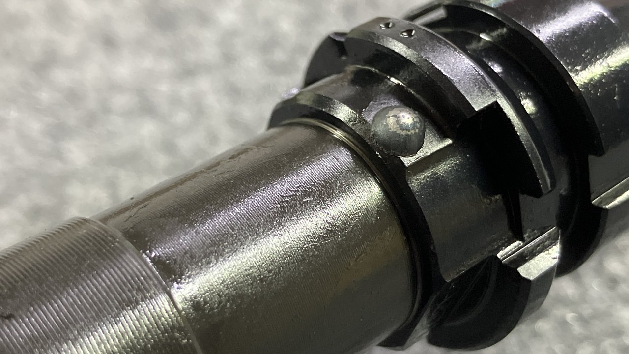 Clean TIG weld bead on a pinned and welded muzzle device