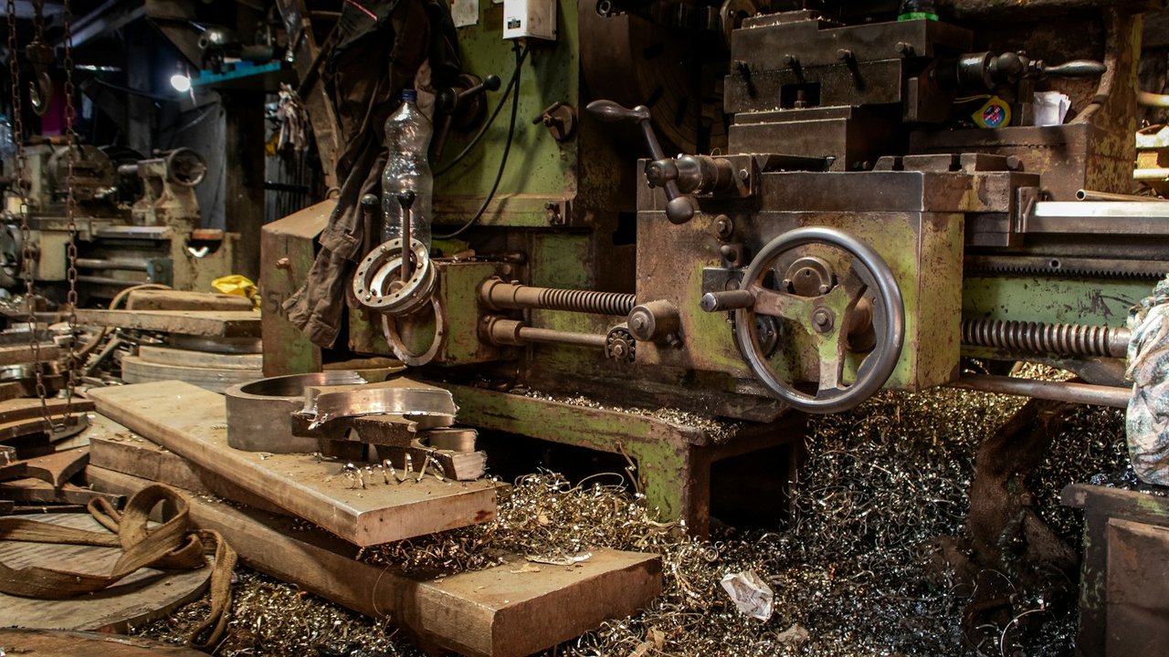 Industrial metal lathe with shavings in a machine shop