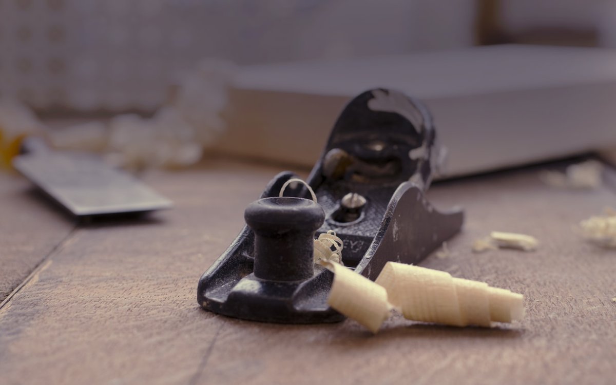 Hand plane and wood shavings on a workbench