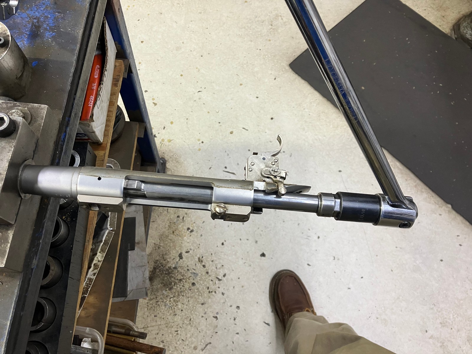 Action wrench on the action while the barrel is held in a barrel vise
