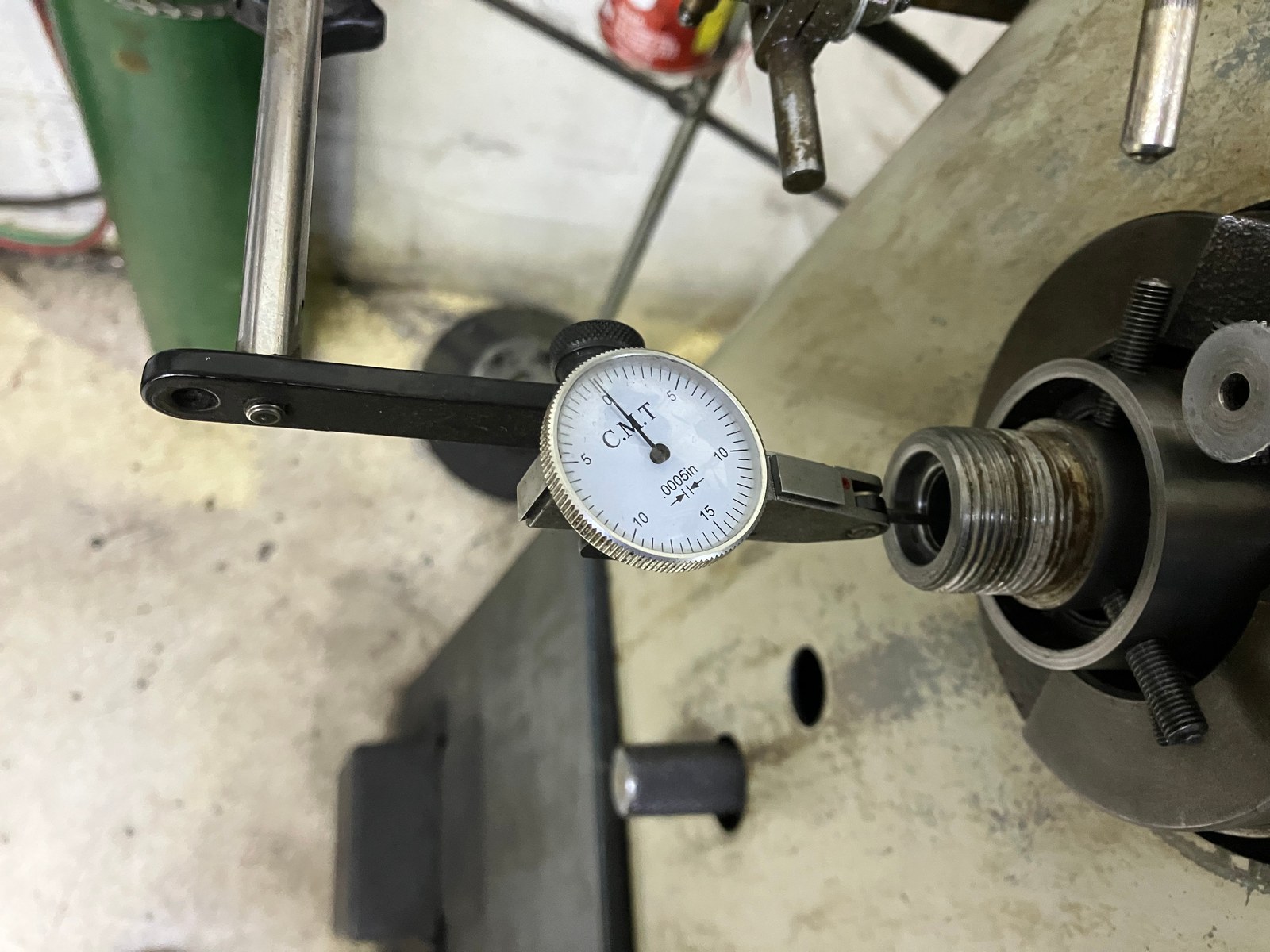 Dial indicator on the chamber end of a barrel fastened in the lathe