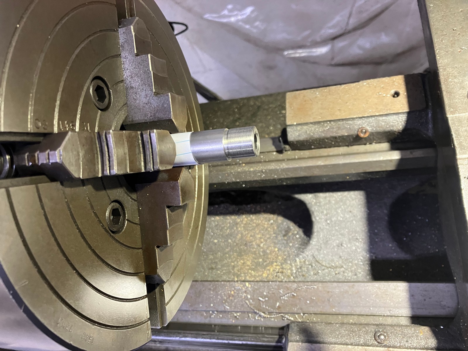 Lathe turning a barrel muzzle down to a 5/8 inch thread diameter