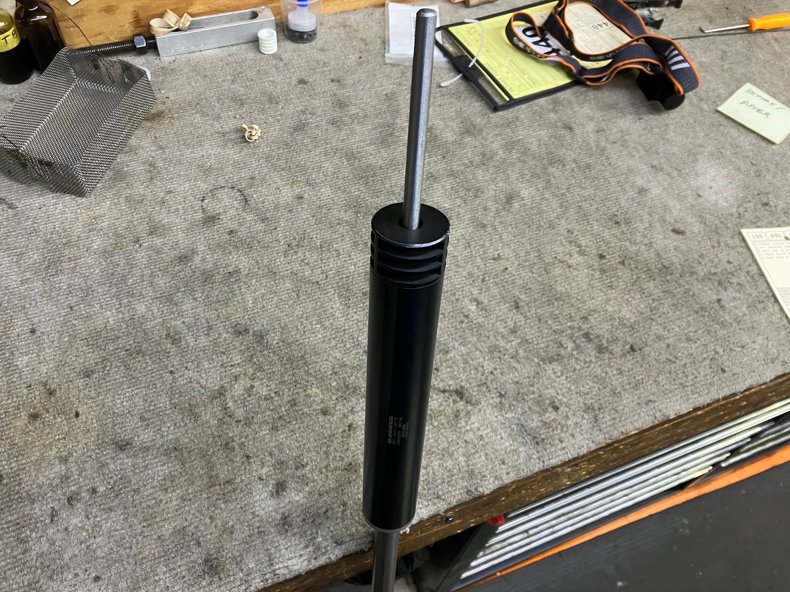 Alignment rod run from the closed bolt through a SilencerCo Harvester shop suppressor