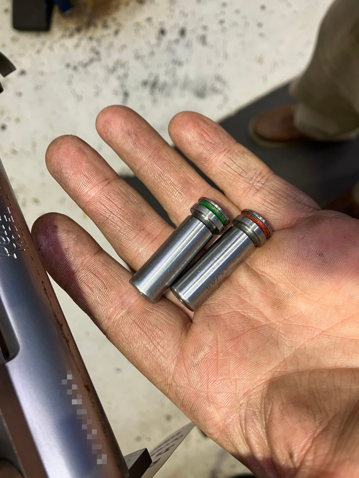 Headspace gauges used to confirm the barrel is installed correctly, with the serial obscured