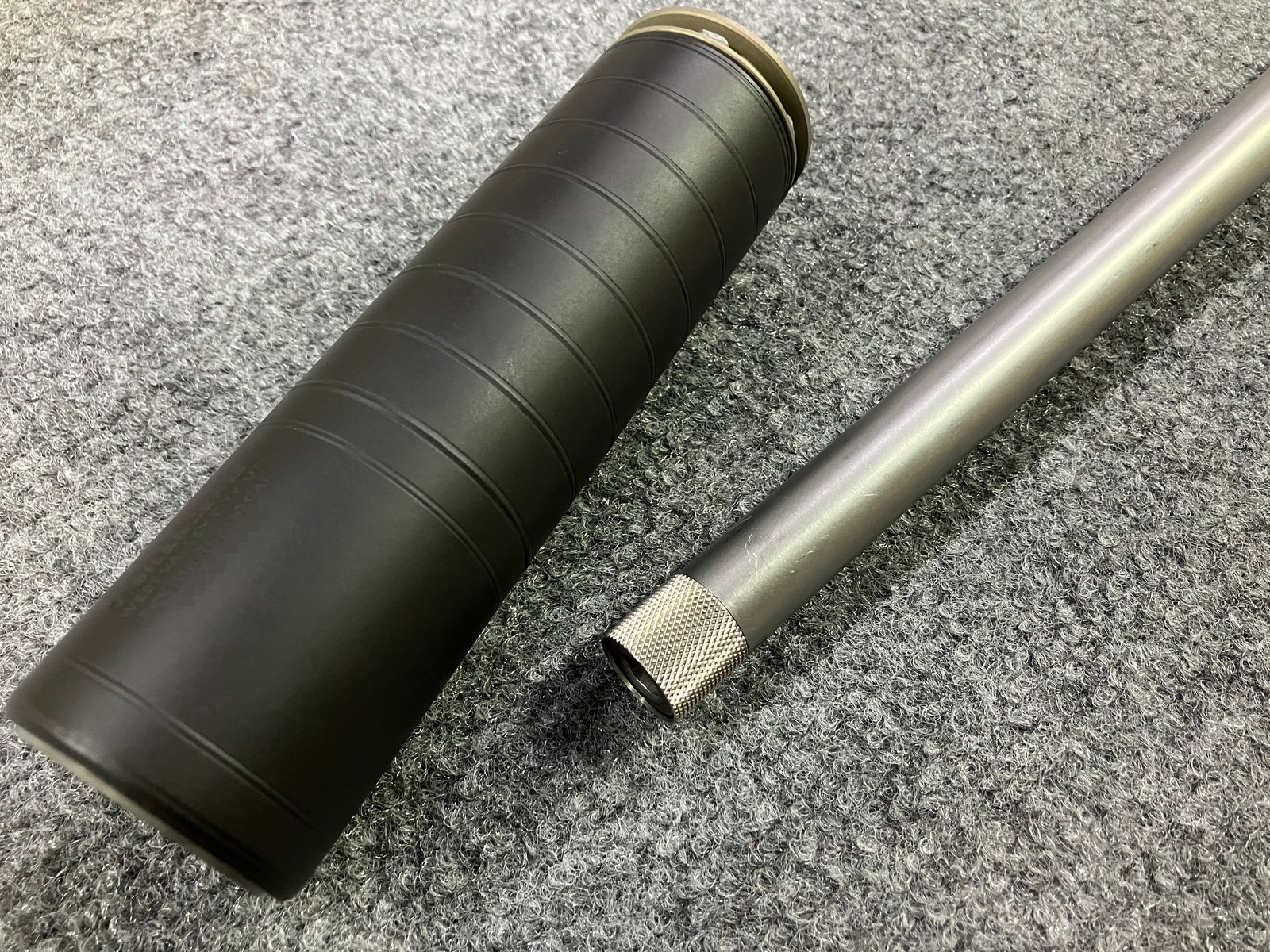 Finished threaded muzzle with a thread protector installed, serial obscured